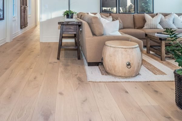 Living room scene with a couch, coffee table, and rug, emphasizing hardwood tile flooring available in San Jose, CA.
